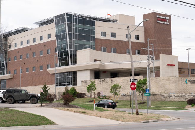 Stormont Vail Healthcare is pursuing a lawsuit seeking $2,400 from a low-income Topeka single mother, whose attorneys say she qualifies for free care.