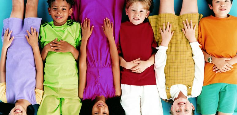 A group of children lying on the floor together.