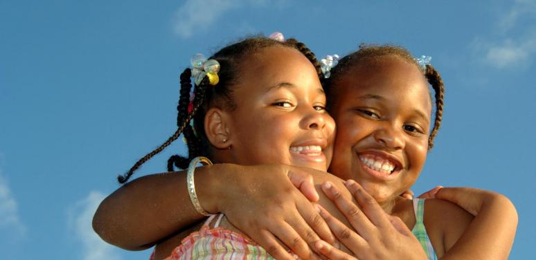 two little black girls hugging