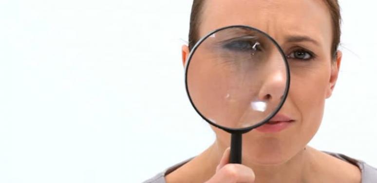 Woman with magnifying glass.