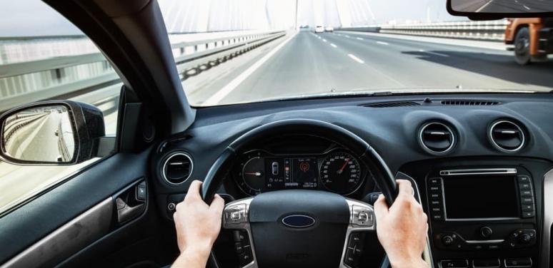 Birds' eye view of hands on a steering wheel